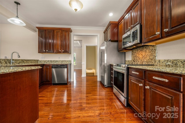 182 Kensington Dr, Forest City, NC 28043 - kitchen with appliances with stainless steel finishes, dark wood-type flooring, light stone counters, tasteful backsplash, and crown molding