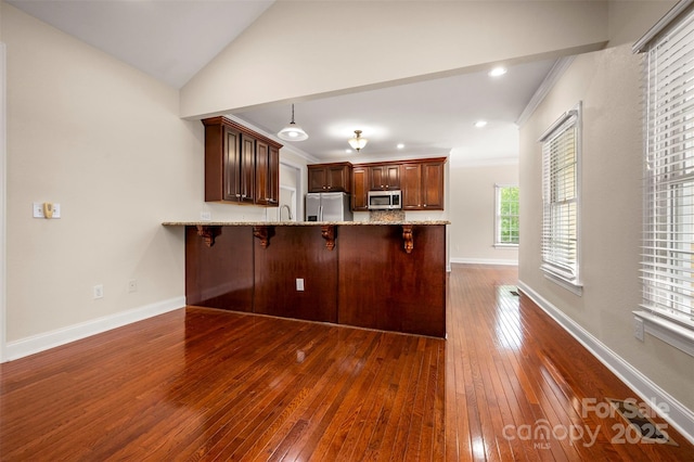 182 Kensington Dr, Forest City, NC 28043 - kitchen with appliances with stainless steel finishes, dark wood-type flooring, a peninsula, light stone counters, and ornamental molding