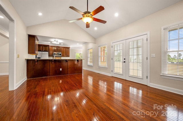 182 Kensington Dr, Forest City, NC 28043 - unfurnished living room featuring dark wood finished floors, ceiling fan, vaulted ceiling, french doors, and baseboards