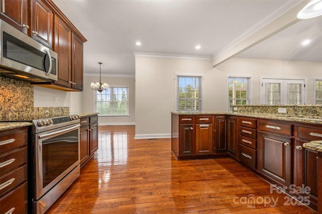 182 Kensington Dr, Forest City, NC 28043 - kitchen with appliances with stainless steel finishes, crown molding, backsplash, dark wood-style floors, and a chandelier