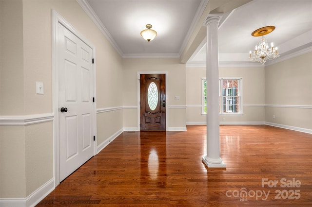 182 Kensington Dr, Forest City, NC 28043 - entrance foyer with wood finished floors, ornate columns, ornamental molding, a chandelier, and baseboards