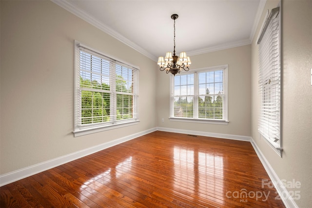 182 Kensington Dr, Forest City, NC 28043 - spare room with a chandelier, plenty of natural light, ornamental molding, hardwood / wood-style flooring, and baseboards