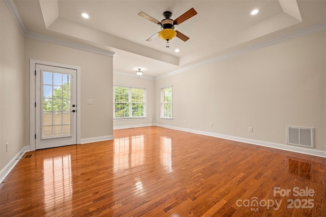 182 Kensington Dr, Forest City, NC 28043 - empty room featuring wood-type flooring, ceiling fan, a tray ceiling, crown molding, and recessed lighting