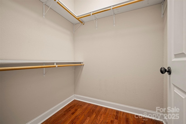 182 Kensington Dr, Forest City, NC 28043 - spacious closet with dark wood-style flooring