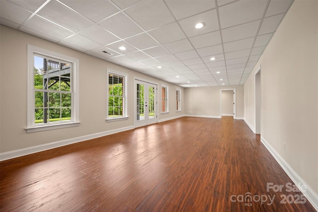 182 Kensington Dr, Forest City, NC 28043 - unfurnished living room featuring wood finished floors, baseboards, a drop ceiling, and recessed lighting