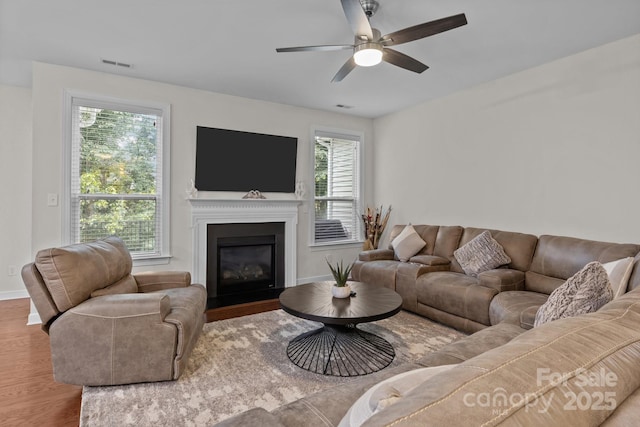 308 Planters Way, Mount Holly, NC 28120 - living room with wood finished floors, a fireplace with flush hearth, baseboards, and ceiling fan
