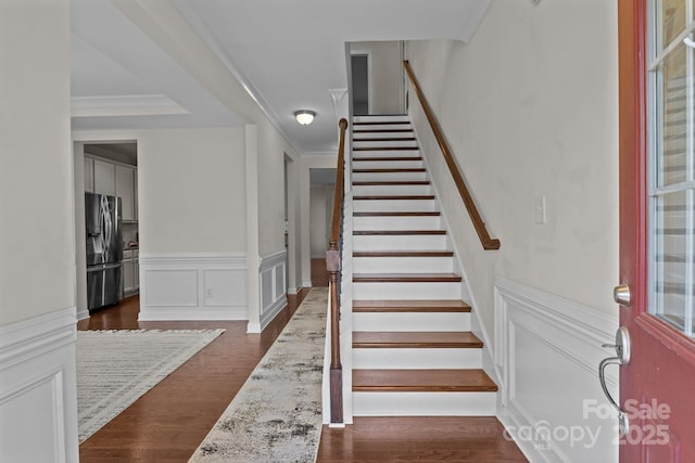 308 Planters Way, Mount Holly, NC 28120 - stairs with wood finished floors, a wainscoted wall, and ornamental molding