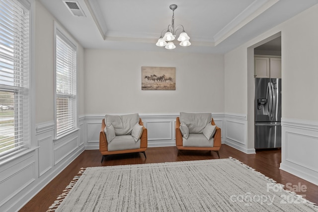 308 Planters Way, Mount Holly, NC 28120 - sitting room with a chandelier, a tray ceiling, dark wood finished floors, a wainscoted wall, and crown molding