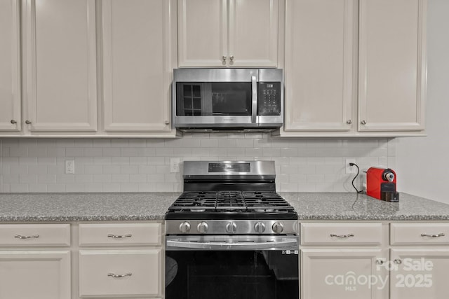 308 Planters Way, Mount Holly, NC 28120 - kitchen with stainless steel appliances, white cabinetry, and tasteful backsplash