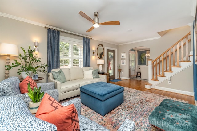 141 Eastover Dr SE, Concord, NC 28025 - living area featuring arched walkways, wood finished floors, a ceiling fan, crown molding, and stairway