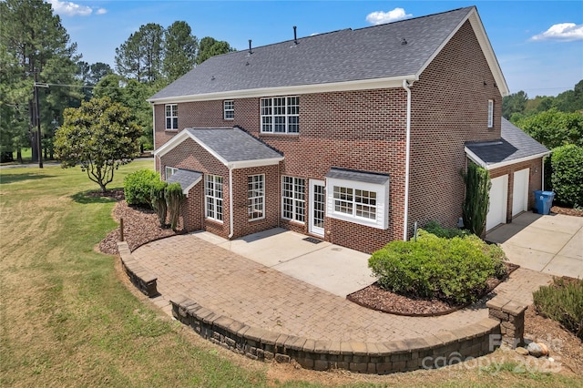 3068 River Rd, Shelby, NC 28152 - back of house featuring brick siding, a garage, a yard, a patio, and roof with shingles