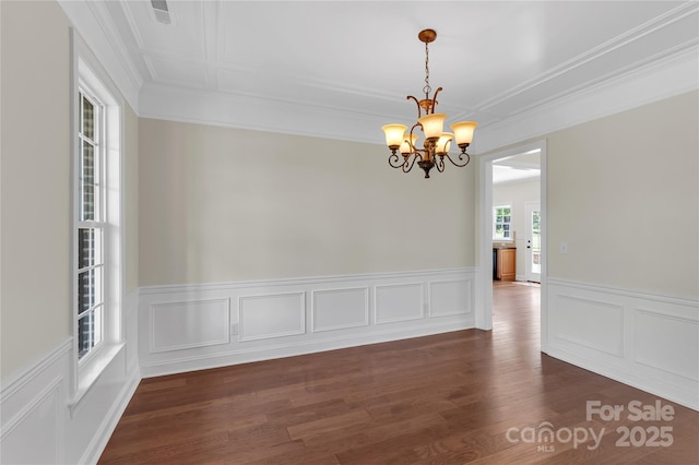 3068 River Rd, Shelby, NC 28152 - spare room featuring a chandelier, ornamental molding, a wainscoted wall, dark wood finished floors, and a decorative wall