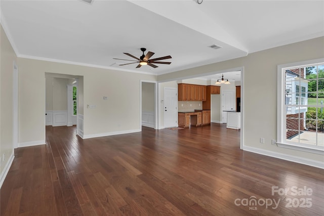 3068 River Rd, Shelby, NC 28152 - unfurnished living room featuring dark wood-style floors, crown molding, a ceiling fan, a chandelier, and baseboards