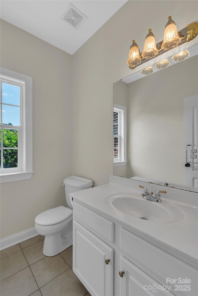 3068 River Rd, Shelby, NC 28152 - half bath featuring tile patterned flooring, plenty of natural light, vanity, and toilet