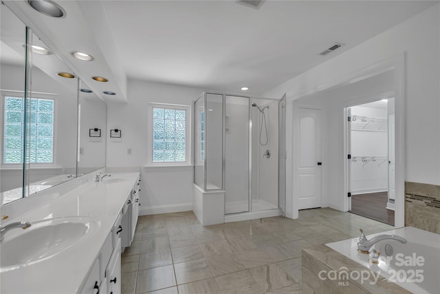 3068 River Rd, Shelby, NC 28152 - full bath featuring a stall shower, a garden tub, double vanity, recessed lighting, and baseboards