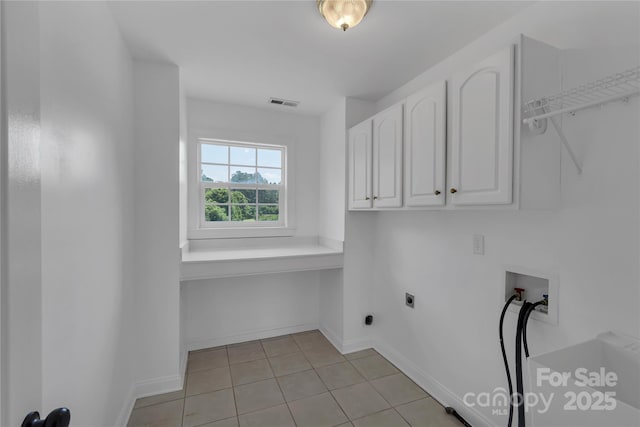 3068 River Rd, Shelby, NC 28152 - washroom with cabinet space, hookup for a washing machine, electric dryer hookup, light tile patterned floors, and baseboards