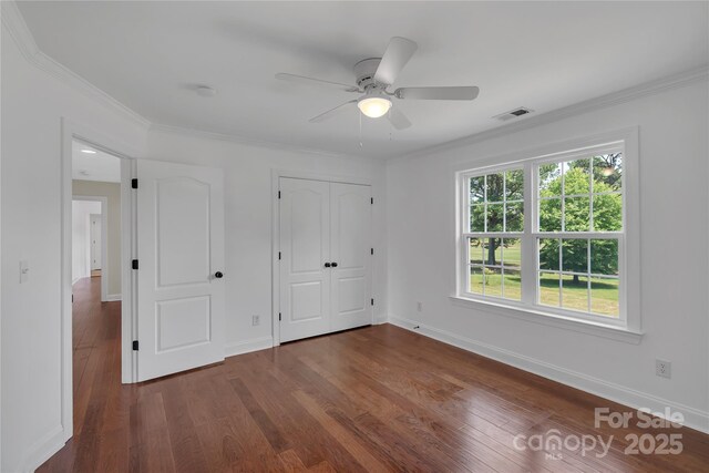 3068 River Rd, Shelby, NC 28152 - unfurnished bedroom featuring dark wood-style floors, crown molding, baseboards, ceiling fan, and a closet