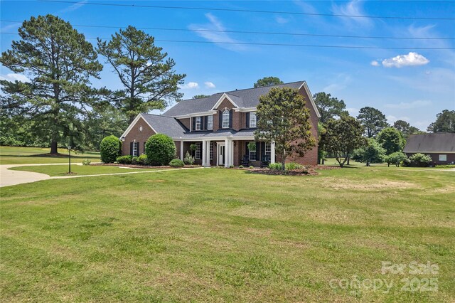 3068 River Rd, Shelby, NC 28152 - view of front of property featuring a front lawn, brick siding, and a porch