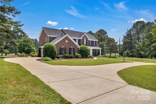 3068 River Rd, Shelby, NC 28152 - view of front of property featuring curved driveway, brick siding, and a front lawn