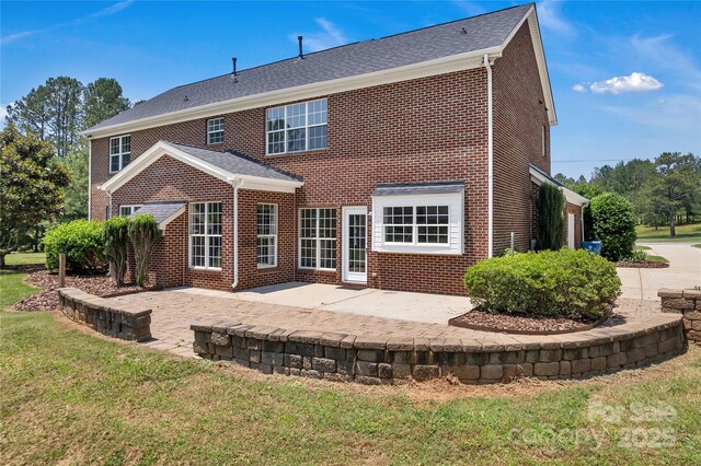 3068 River Rd, Shelby, NC 28152 - rear view of house with brick siding, a patio, and a yard