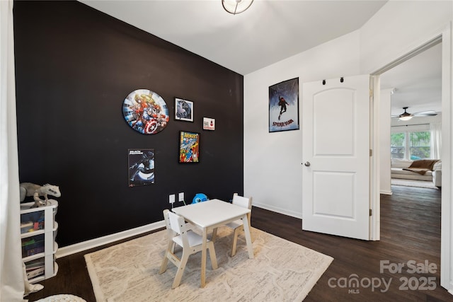 5113 Saddleback Dr, Mount Holly, NC 28120 - rec room with wood finished floors, baseboards, and a ceiling fan
