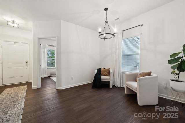 5113 Saddleback Dr, Mount Holly, NC 28120 - sitting room featuring a chandelier, dark wood-type flooring, and baseboards