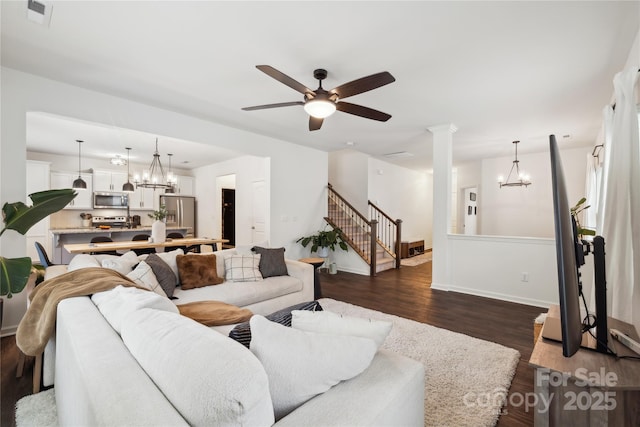 5113 Saddleback Dr, Mount Holly, NC 28120 - living area with a chandelier, dark wood-style flooring, stairs, and a ceiling fan