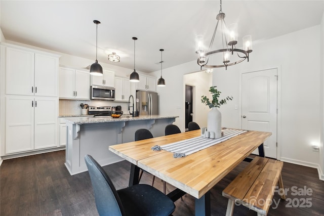 5113 Saddleback Dr, Mount Holly, NC 28120 - dining room featuring dark wood-style floors and a chandelier
