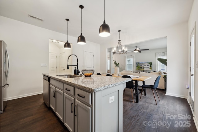 5113 Saddleback Dr, Mount Holly, NC 28120 - kitchen featuring a sink, gray cabinetry, dark wood finished floors, stainless steel appliances, and light stone countertops