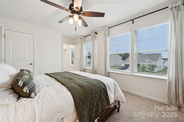 5113 Saddleback Dr, Mount Holly, NC 28120 - carpeted bedroom featuring baseboards, multiple windows, and ceiling fan