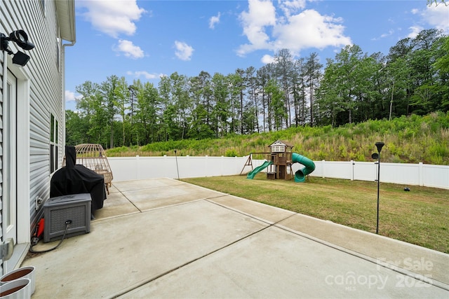 5113 Saddleback Dr, Mount Holly, NC 28120 - view of patio with a playground and view of scattered trees