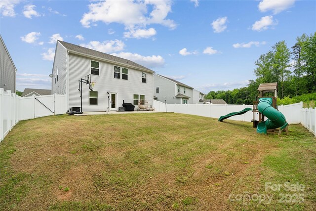 5113 Saddleback Dr, Mount Holly, NC 28120 - back of house with a playground and a patio area