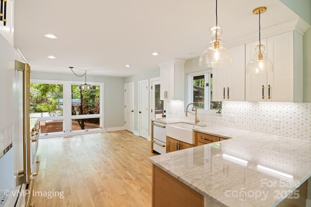 449 Windward Dr, Davidson, NC 28036 - kitchen with a sink, healthy amount of natural light, decorative backsplash, light wood finished floors, and recessed lighting