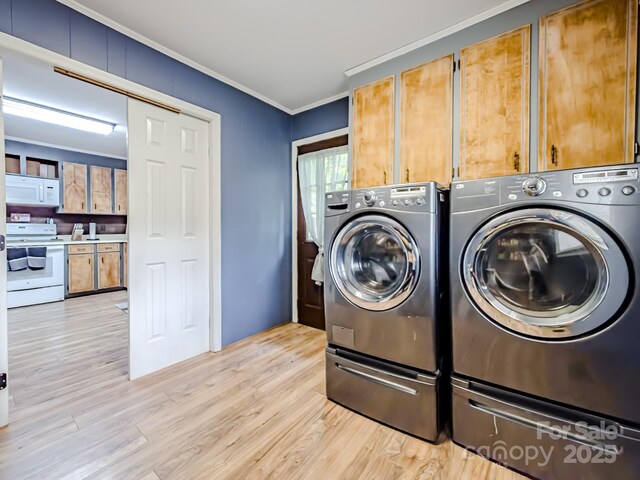 206 Logan Dr, Blacksburg, SC 29702 - washroom with cabinet space, washing machine and clothes dryer, ornamental molding, and light wood finished floors