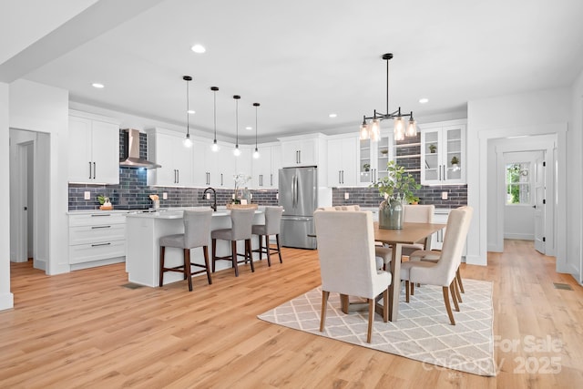 106 Arbor Dr, Waxhaw, NC 28173 - dining room with light wood-style flooring, a chandelier, and recessed lighting