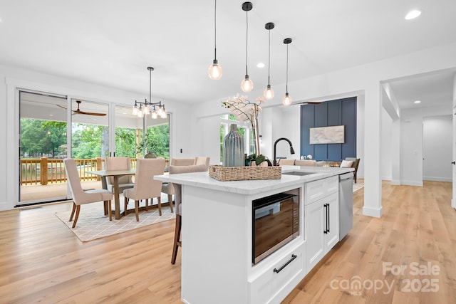106 Arbor Dr, Waxhaw, NC 28173 - kitchen featuring black microwave, a sink, dishwasher, light wood-type flooring, and recessed lighting