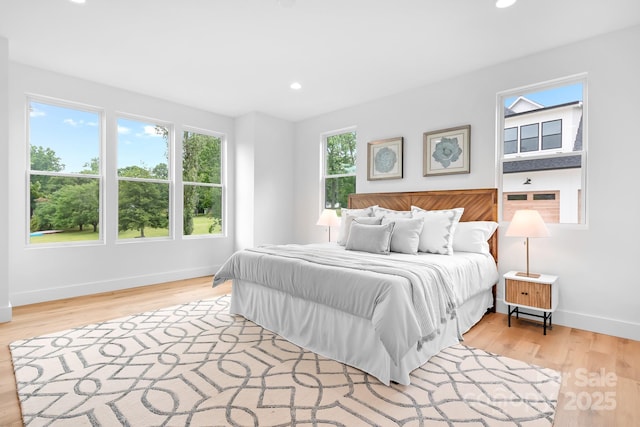 106 Arbor Dr, Waxhaw, NC 28173 - bedroom featuring multiple windows, baseboards, wood finished floors, and recessed lighting
