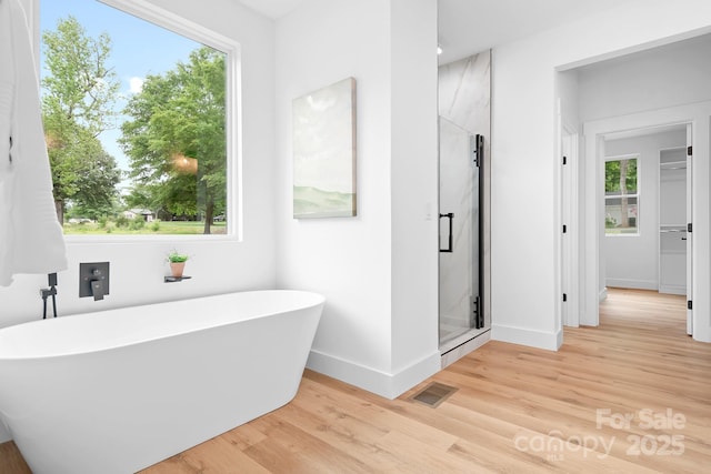 106 Arbor Dr, Waxhaw, NC 28173 - full bath featuring a freestanding tub, baseboards, wood finished floors, and a stall shower