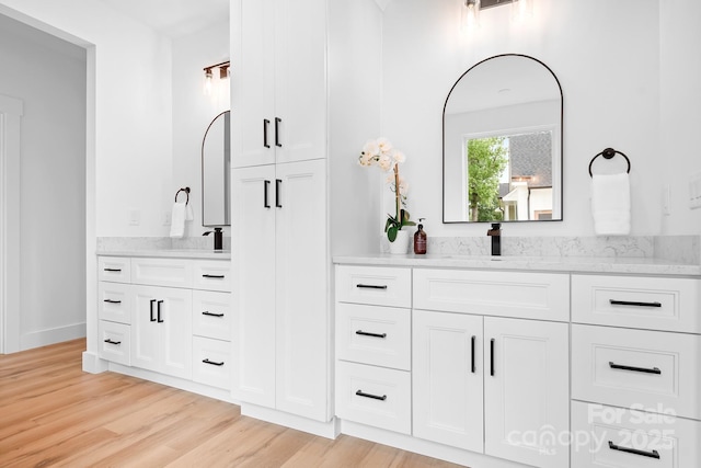 106 Arbor Dr, Waxhaw, NC 28173 - full bath featuring wood finished floors, two vanities, and baseboards