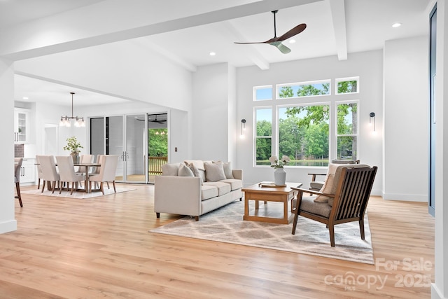 106 Arbor Dr, Waxhaw, NC 28173 - living area with plenty of natural light, a ceiling fan, light wood-style flooring, beam ceiling, and a chandelier