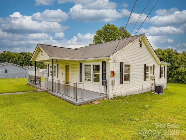 201 Robinson Rd, Gastonia, NC 28056 - view of front of house with a porch, a front lawn, a shingled roof, and cooling unit