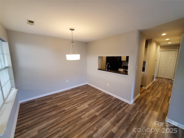 5003 Sharon Rd Unit Q, Charlotte, NC 28210 - unfurnished living room with dark wood-type flooring, baseboards, recessed lighting, and a sink