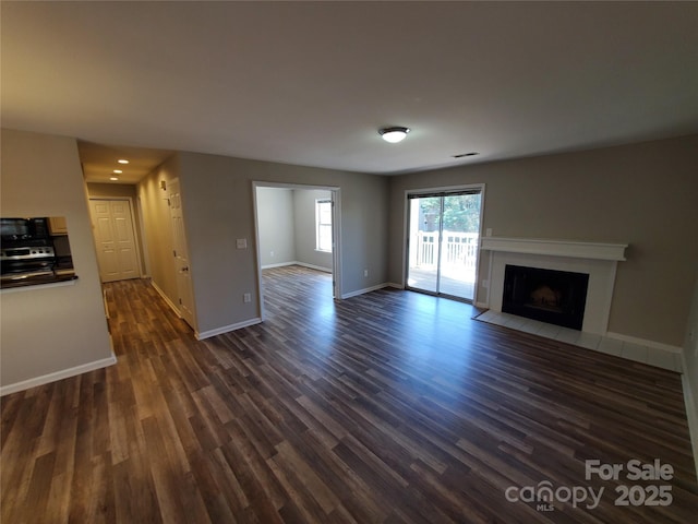 5003 Sharon Rd Unit Q, Charlotte, NC 28210 - unfurnished living room with dark wood-type flooring, baseboards, and a fireplace with flush hearth
