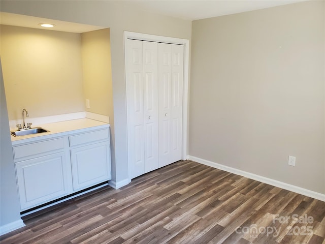 5003 Sharon Rd Unit Q, Charlotte, NC 28210 - unfurnished bedroom featuring dark wood-style floors, a closet, baseboards, and recessed lighting