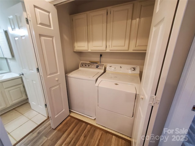 5003 Sharon Rd Unit Q, Charlotte, NC 28210 - laundry room with washer and dryer, cabinet space, and light wood-type flooring
