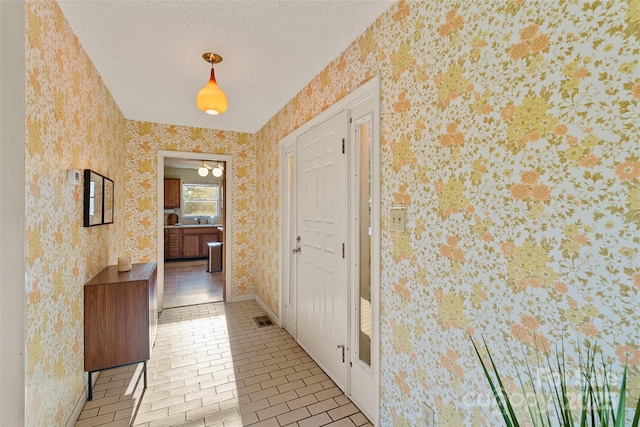 55 Dane Acres Dr, Alexander, NC 28701 - corridor with wallpapered walls, baseboards, light tile patterned floors, and a textured ceiling