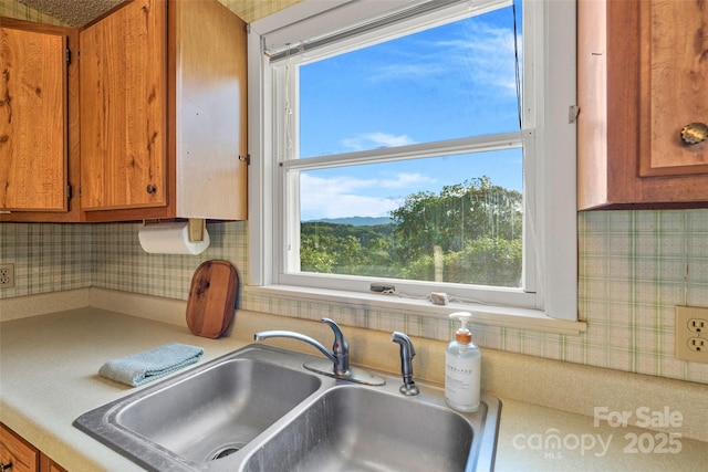 55 Dane Acres Dr, Alexander, NC 28701 - kitchen with a sink, brown cabinets, and plenty of natural light