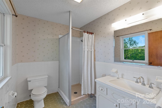 55 Dane Acres Dr, Alexander, NC 28701 - full bath with wallpapered walls, tile walls, vanity, a wainscoted wall, and toilet