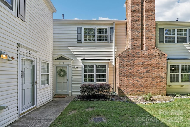 8510 Castle Pine Ct, Charlotte, NC 28226 - doorway to property featuring a yard and a chimney