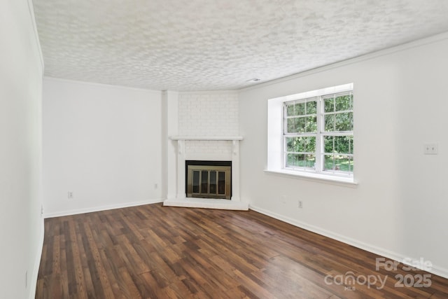 8510 Castle Pine Ct, Charlotte, NC 28226 - unfurnished living room featuring a brick fireplace, ornamental molding, dark wood-type flooring, and baseboards